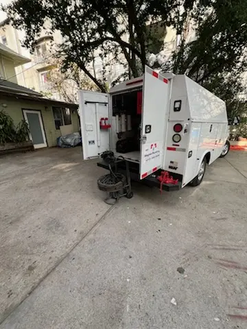 Magnet Plumbing service vehicle on-site for Grease Trap Cleaning in Clark District